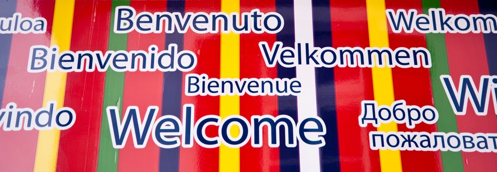 Colorful sign showing the world welcome in different languages.